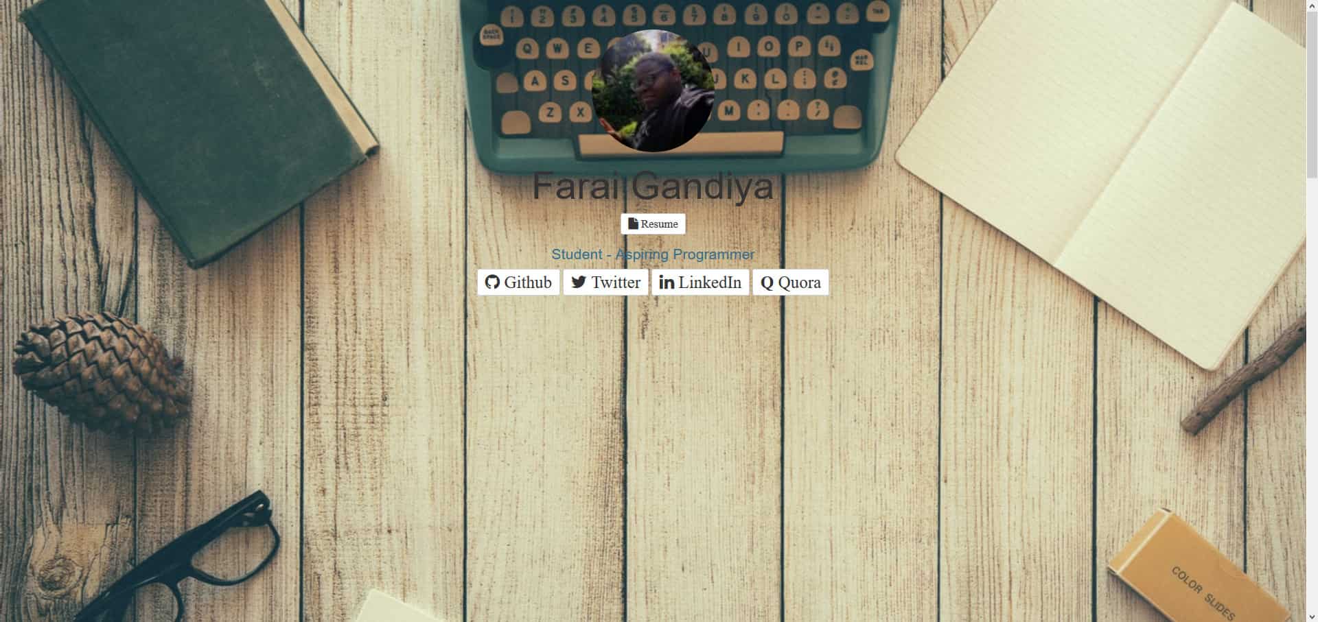 The second version of my personal website, with a picture of me and some information on social links and resume against a background featuring a table with a typewriter.